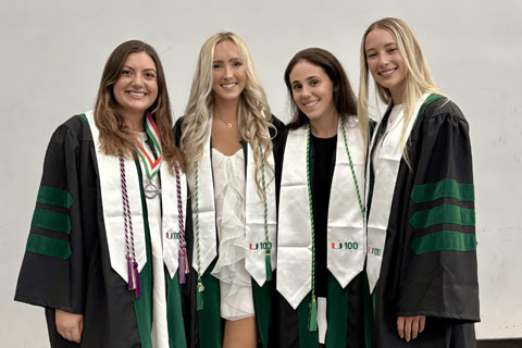 Alumni gathered wearing graduation gowns