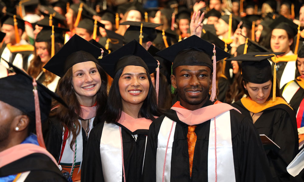 Alumni smiling durning commencement ceremony