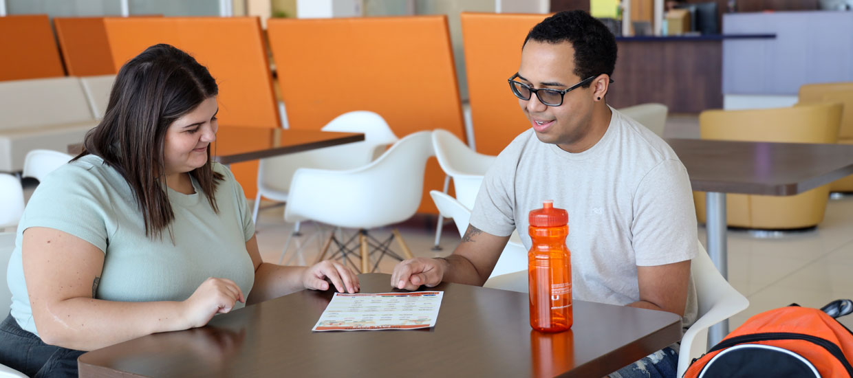 Students sitting and reviewing a document